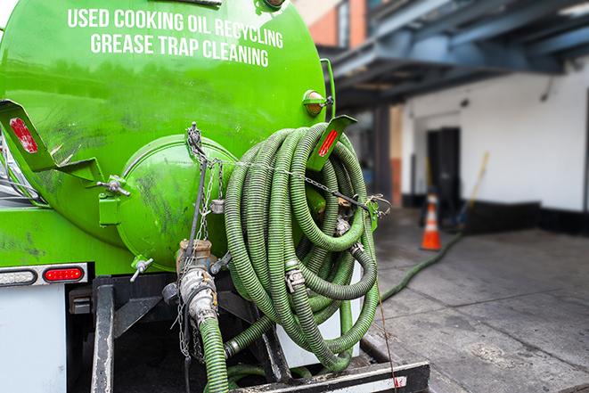 a grease trap being pumped by a sanitation technician in Encino